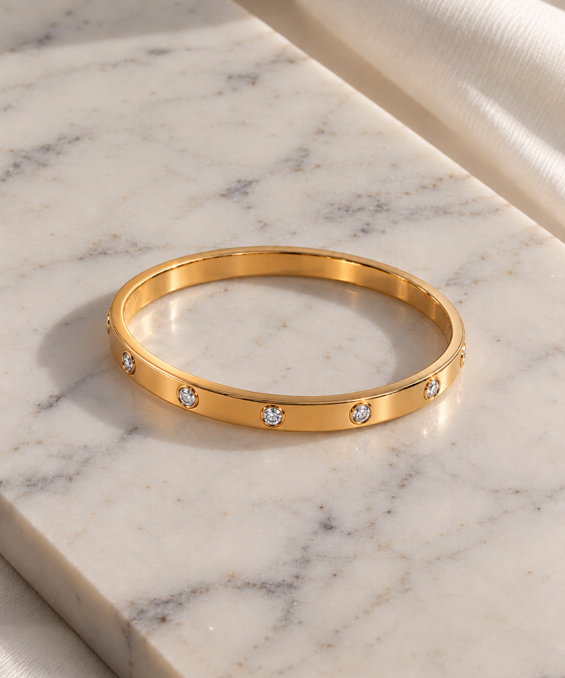 Valentina diamond-set gold bangle on marble